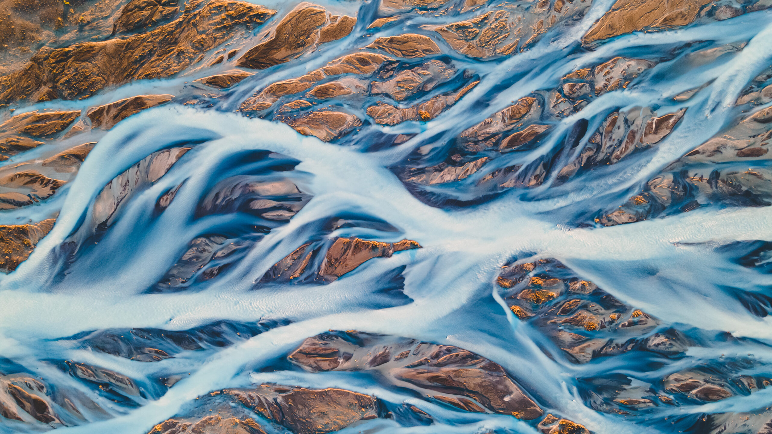 A glacial rivers from above. Aerial photograph of the river streams from Icelandic glaciers. Beautiful art of the Mother nature created in Iceland. Wallpaper background high quality photo